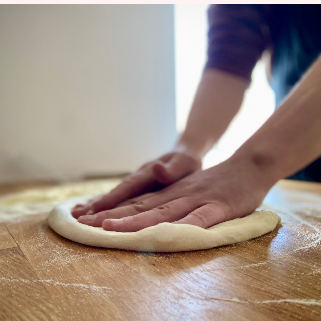 Stretching pizza base by hand